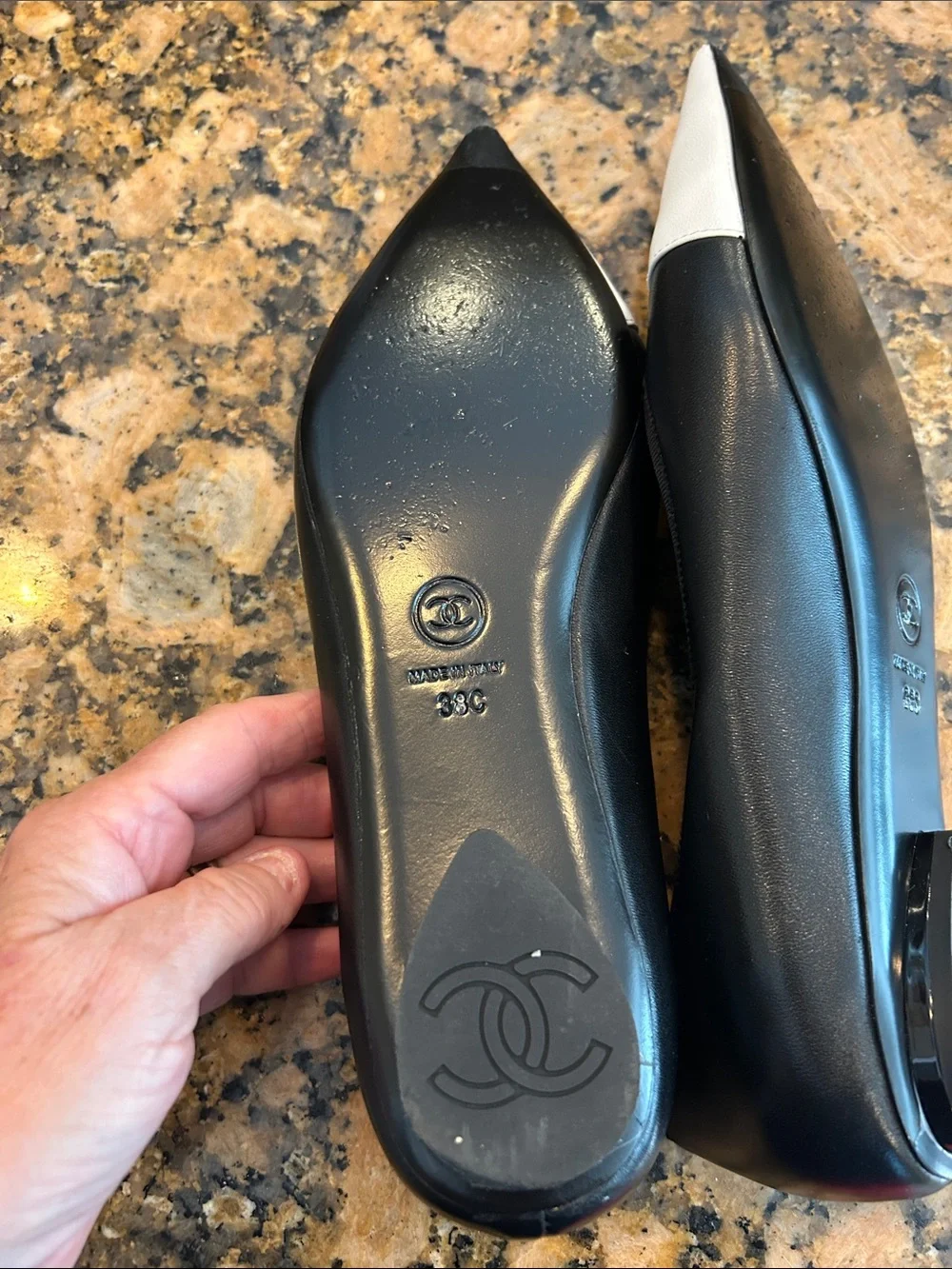 CHANEL Black Leather Flats with White Pointed Toe and CC Stitching